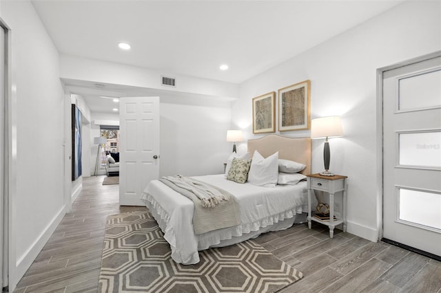 bedroom with recessed lighting, baseboards, visible vents, and wood finish floors