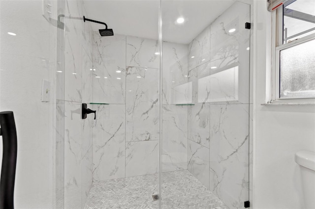 full bathroom with toilet and a marble finish shower