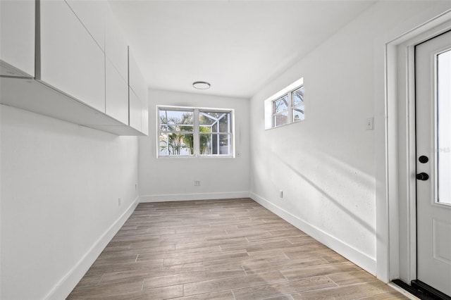 unfurnished room featuring light wood-style flooring and baseboards