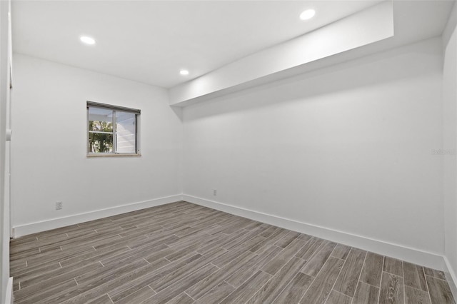 below grade area with wood finish floors, baseboards, and recessed lighting