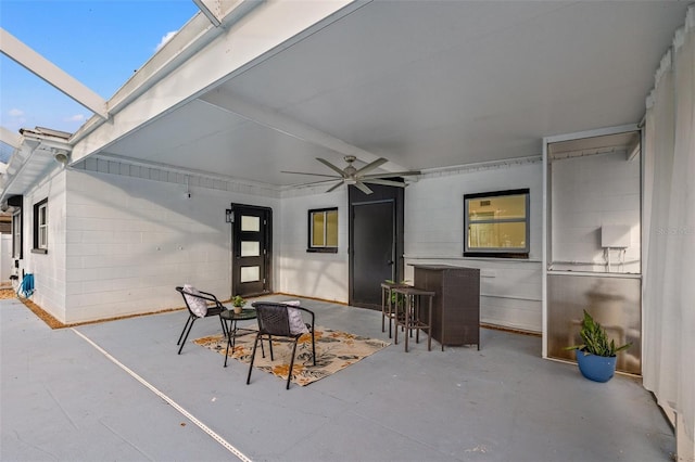 view of patio / terrace featuring glass enclosure and ceiling fan