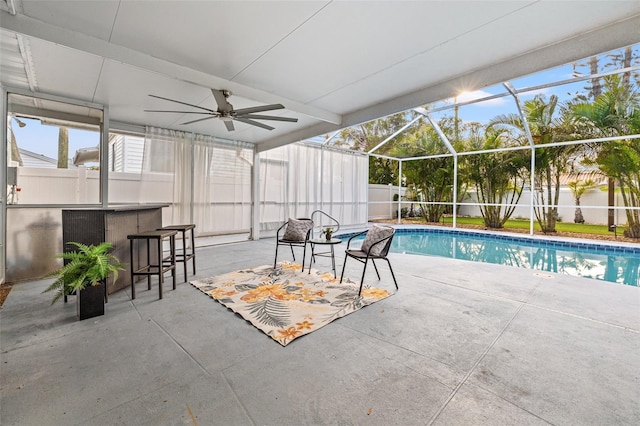 view of pool with a fenced backyard, a lanai, outdoor dry bar, a fenced in pool, and a patio area