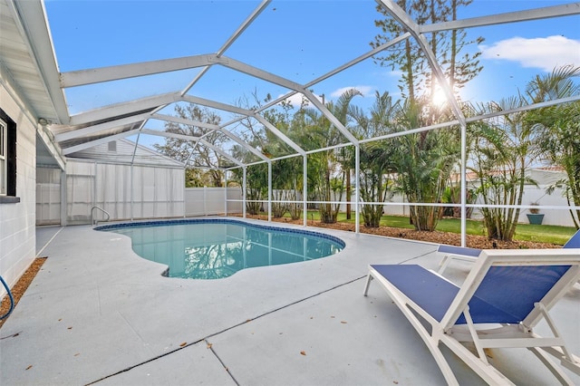 view of swimming pool featuring a fenced in pool, glass enclosure, a patio area, and a fenced backyard