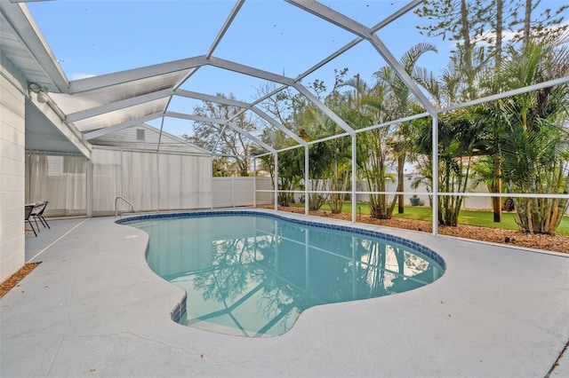 outdoor pool with a patio, a fenced backyard, and a lanai