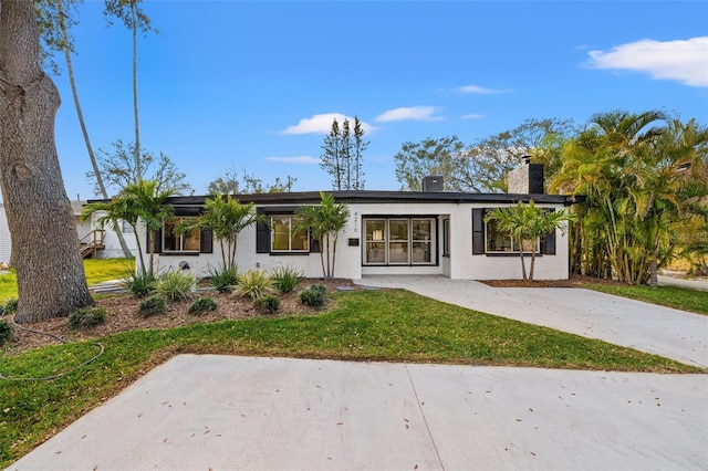 view of front of property with a front lawn and stucco siding