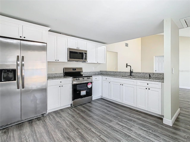 kitchen featuring sink, light stone countertops, white cabinets, and appliances with stainless steel finishes