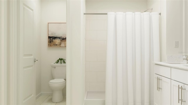 bathroom with tiled shower, tile patterned floors, vanity, and toilet