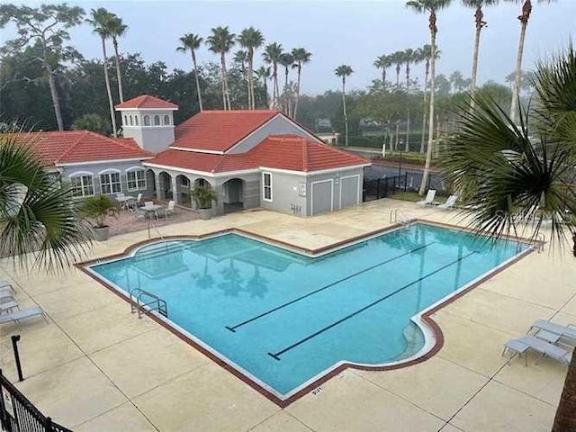 view of swimming pool with a patio area