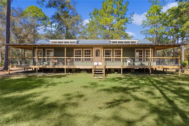 rear view of house with a yard and a deck