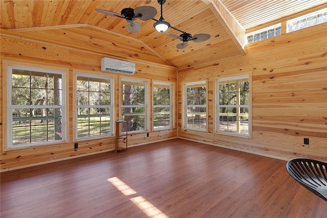 unfurnished sunroom with ceiling fan, vaulted ceiling, a wall unit AC, and wood ceiling