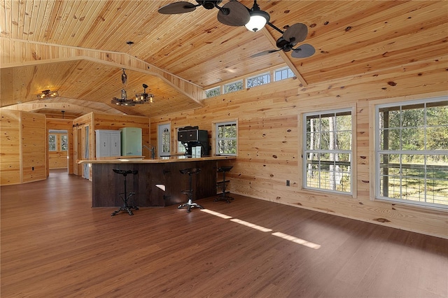 interior space with wood ceiling, wooden walls, hardwood / wood-style floors, and vaulted ceiling