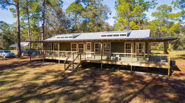 rear view of house with a wooden deck