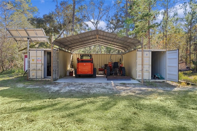 view of outbuilding with a carport and a lawn