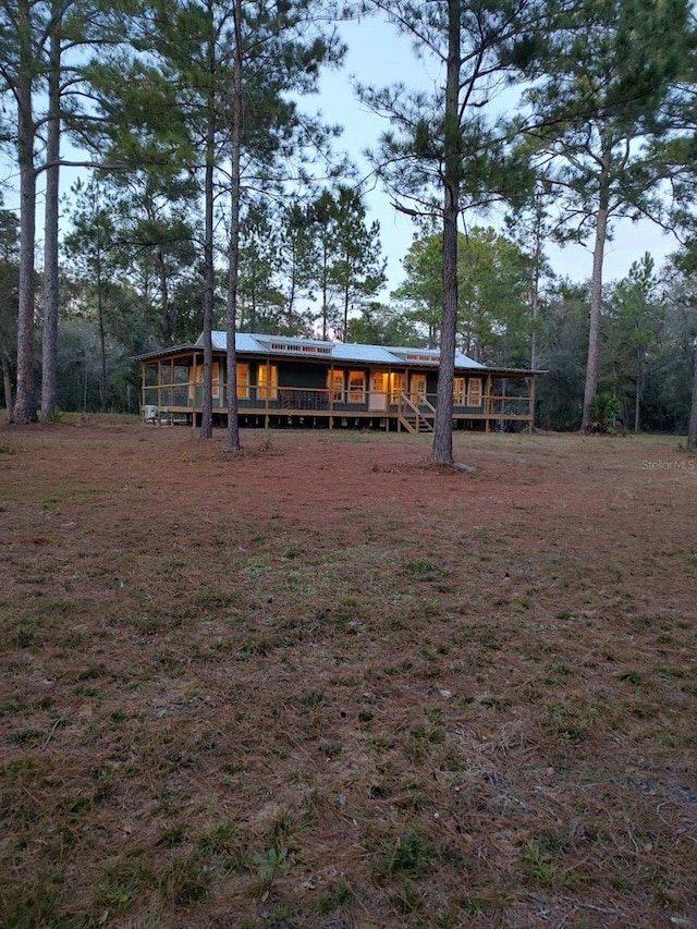 rear view of property with a wooden deck