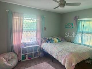 bedroom with multiple windows and ceiling fan