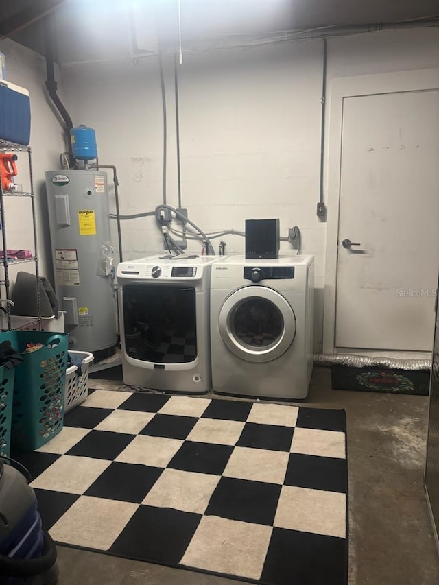 clothes washing area featuring water heater and independent washer and dryer