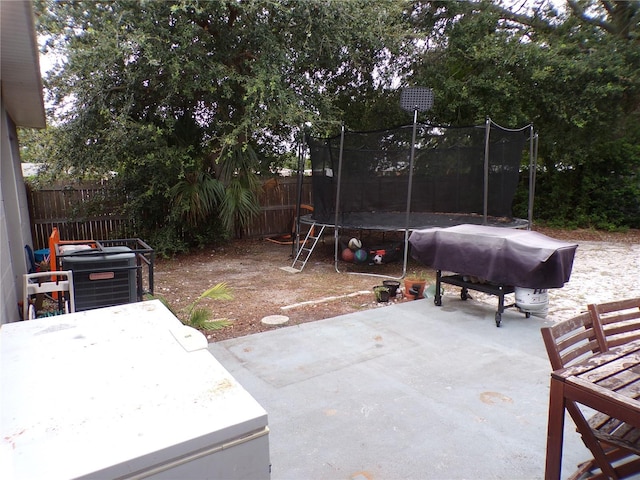 view of patio featuring area for grilling and a trampoline