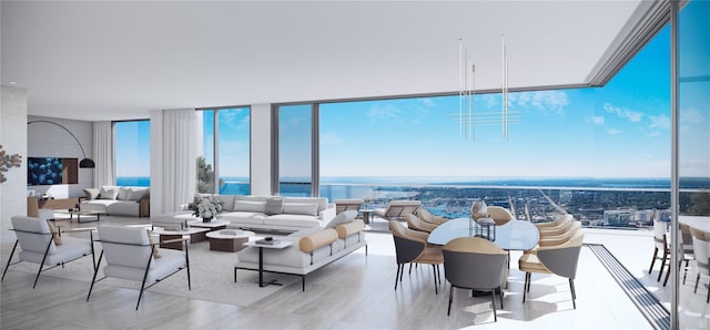 living room featuring a water view, floor to ceiling windows, and light hardwood / wood-style floors