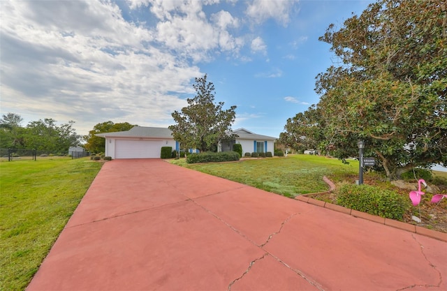 view of front of house featuring a garage and a front lawn