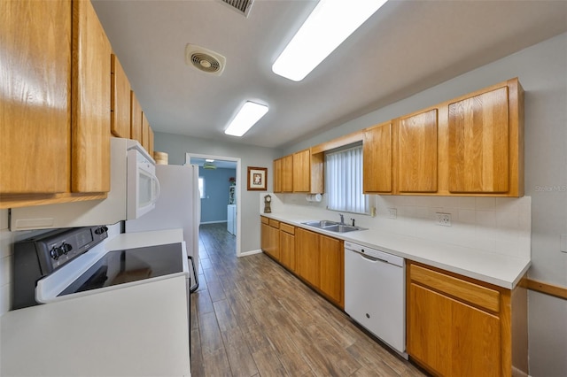 kitchen featuring dark hardwood / wood-style flooring, sink, white dishwasher, and electric stove