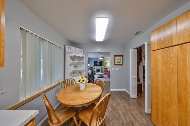 dining room featuring dark wood-type flooring and ceiling fan