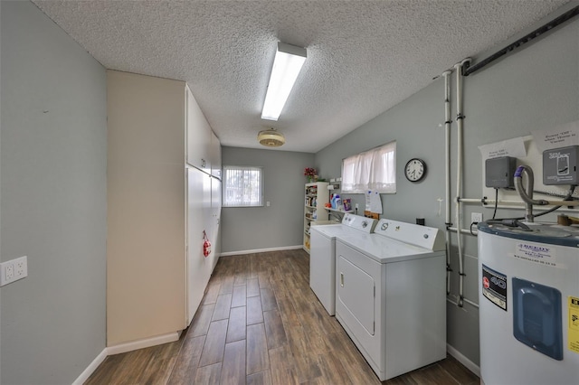 washroom featuring separate washer and dryer, dark wood-type flooring, electric water heater, and a textured ceiling