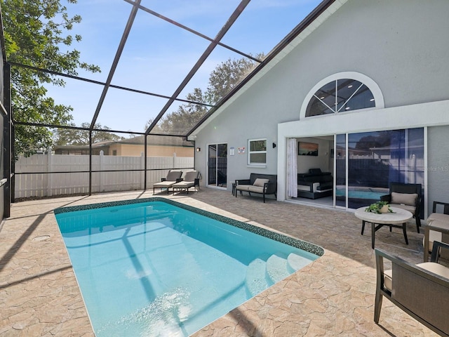 view of swimming pool with outdoor lounge area, a patio area, and a lanai