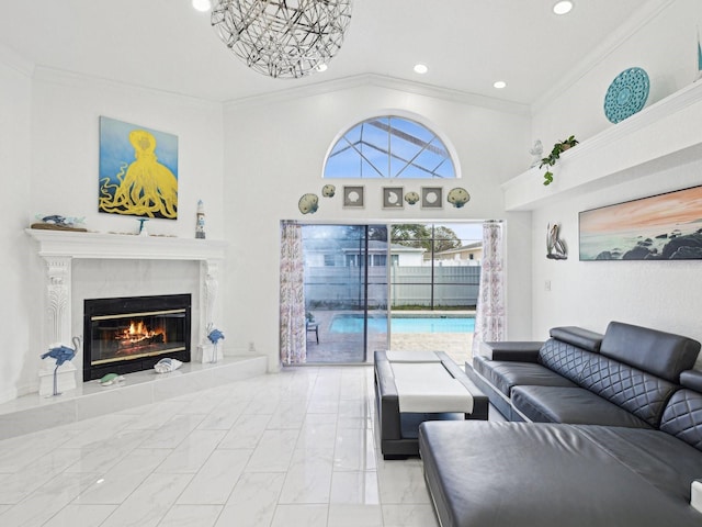 living room with crown molding, a high end fireplace, and a high ceiling