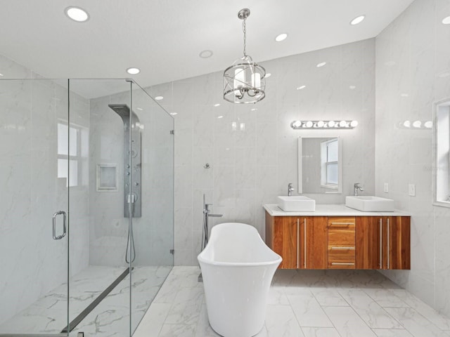 bathroom with vanity, independent shower and bath, and tile walls