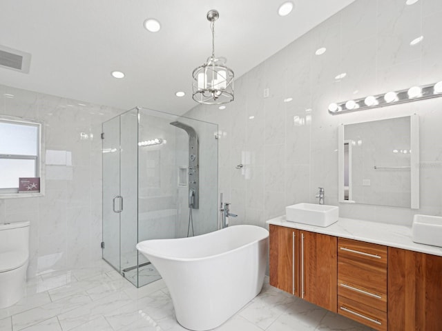 full bathroom with toilet, an inviting chandelier, separate shower and tub, tile walls, and vanity