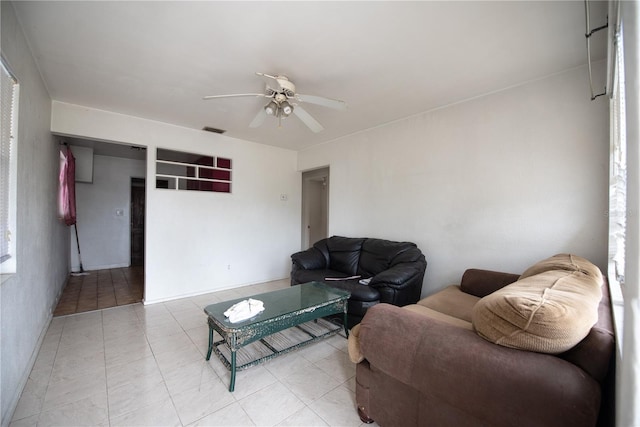 living room with ceiling fan and light tile patterned floors