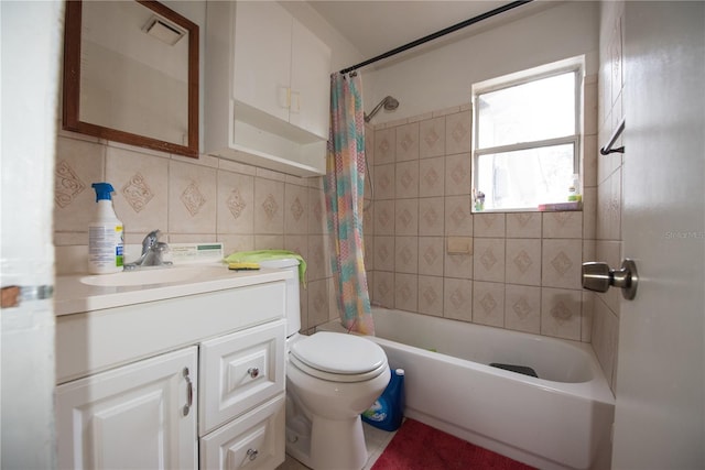 full bathroom featuring tile walls, backsplash, vanity, toilet, and shower / bath combo with shower curtain