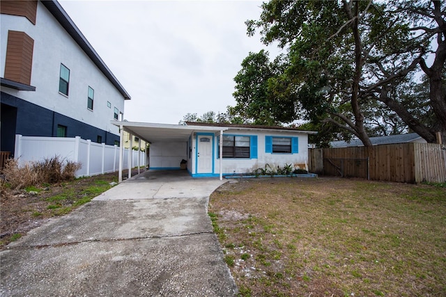 view of front of house with a carport, central AC unit, and a front lawn