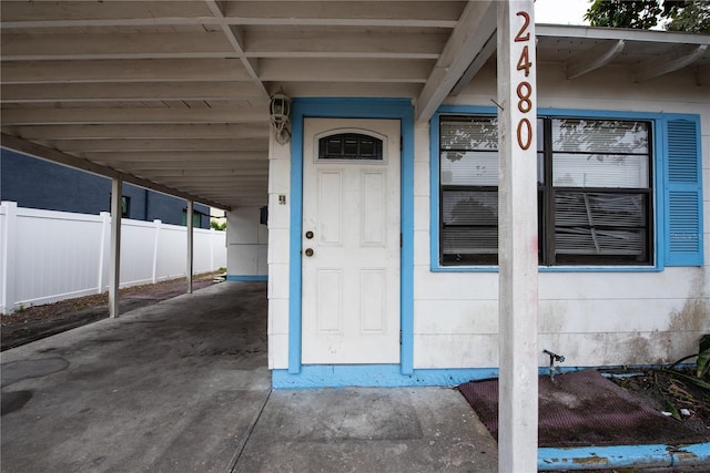 property entrance with a carport