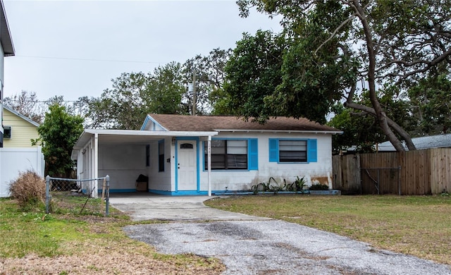 view of front of home featuring a carport and a front lawn