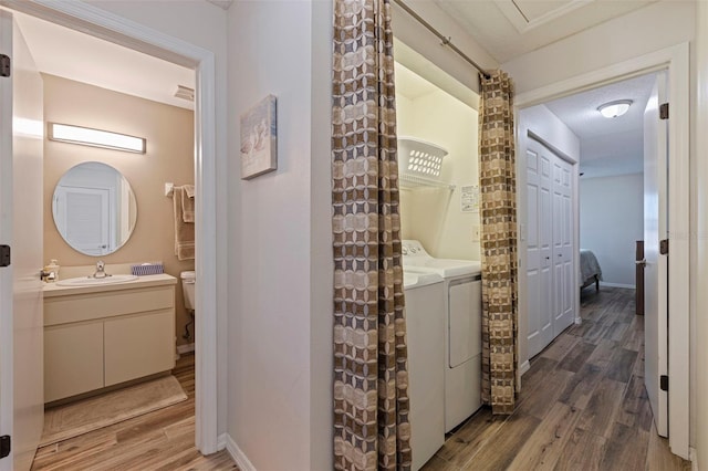 hallway featuring dark hardwood / wood-style flooring, sink, and independent washer and dryer