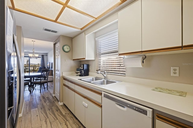 kitchen with white cabinets, dishwasher, sink, and stainless steel fridge with ice dispenser