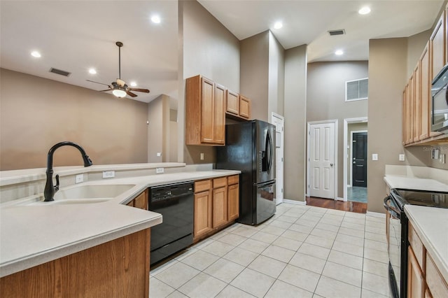 kitchen featuring light tile patterned flooring, ceiling fan, sink, and black appliances