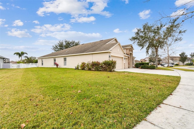 view of property exterior with a yard and a garage