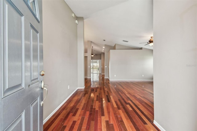 foyer featuring dark wood-type flooring, ceiling fan, and vaulted ceiling