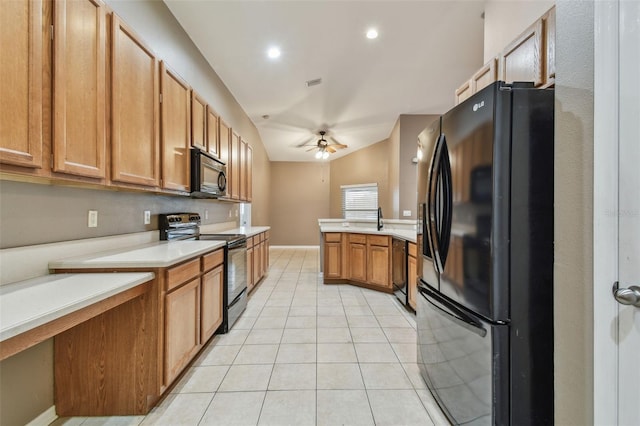 kitchen featuring lofted ceiling, light tile patterned floors, sink, ceiling fan, and black appliances