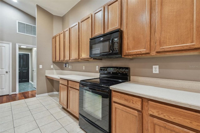 kitchen featuring light tile patterned floors and black appliances