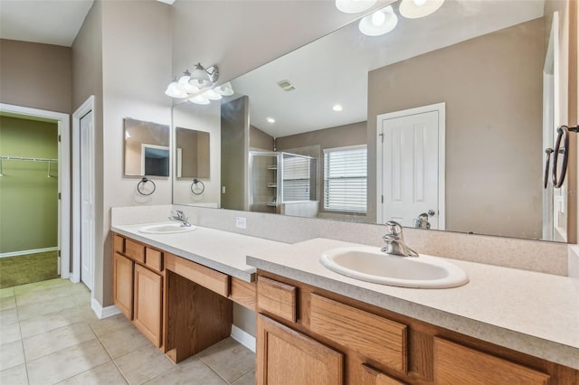 bathroom with vanity, a shower with shower door, and tile patterned floors