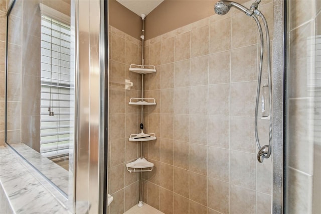 bathroom with a tile shower