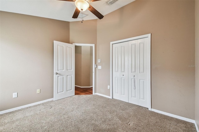 unfurnished bedroom with carpet floors, a closet, and ceiling fan