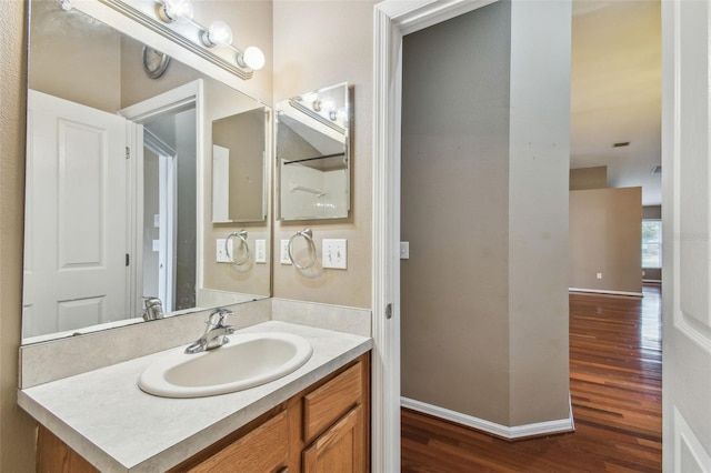 bathroom with hardwood / wood-style flooring and vanity