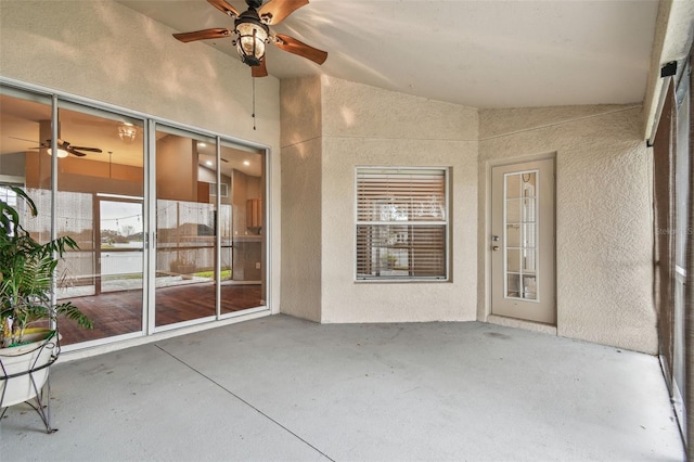 unfurnished sunroom with vaulted ceiling and ceiling fan