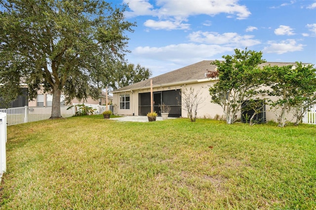 back of house featuring a yard and a patio area