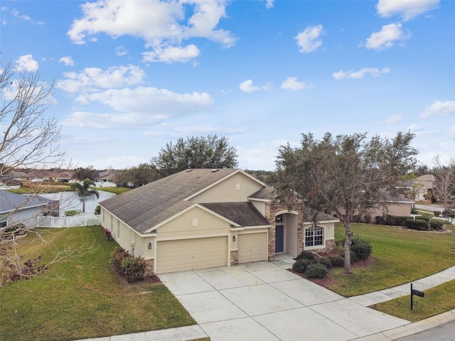 view of front of home featuring a garage, a water view, and a front yard