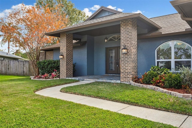 property entrance featuring a lawn